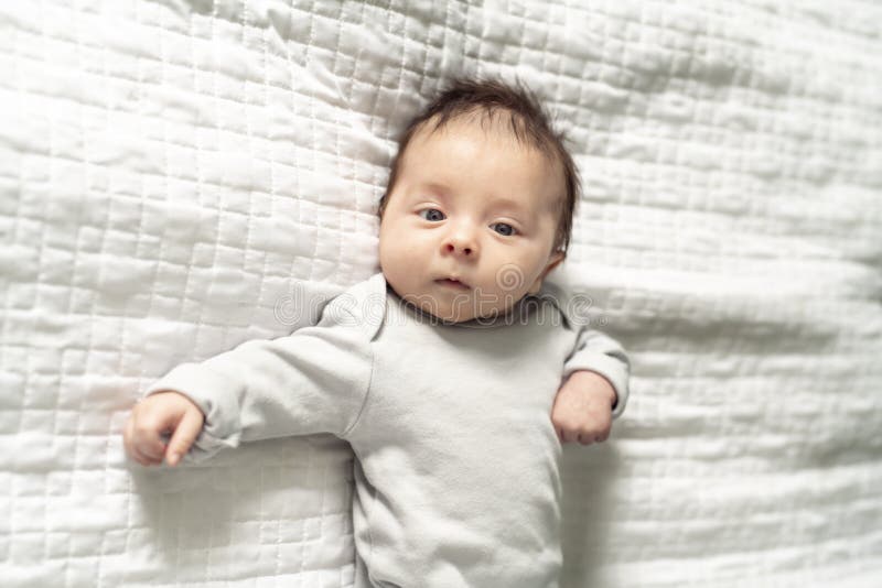 A Happy Newborn Baby on the Bed at Home Stock Image Image of lying