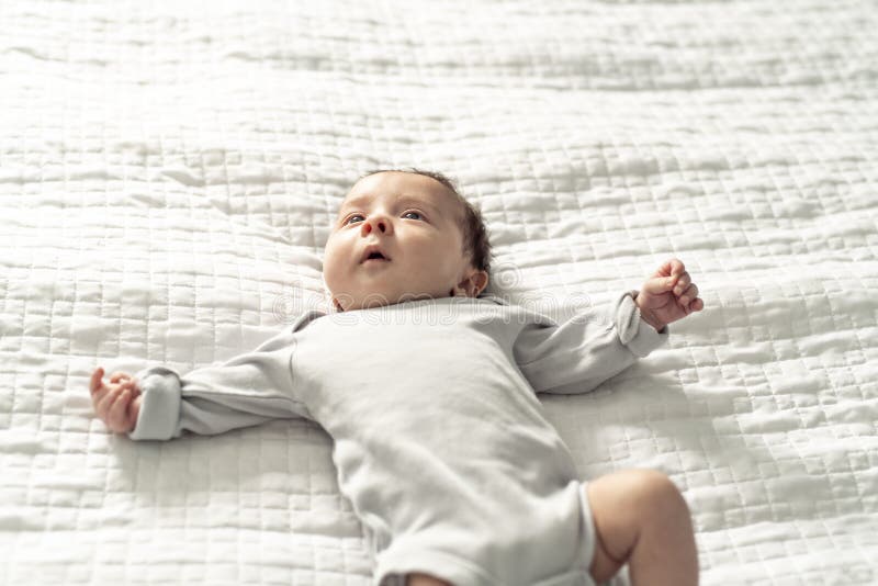 A Happy Newborn Baby on the Bed at Home Stock Photo Image of innocent