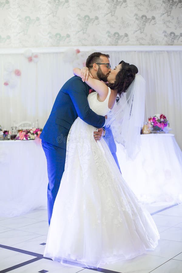 Happy newlywed couple kissing during their first dance at wedding reception royalty free stock images Happy newlywed couple kissing during their first dance at wedding reception royalty free stock images