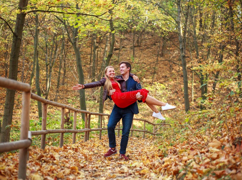 Happy Newlyweds Couple In Love In Forest Park Having Fun Guy Carries