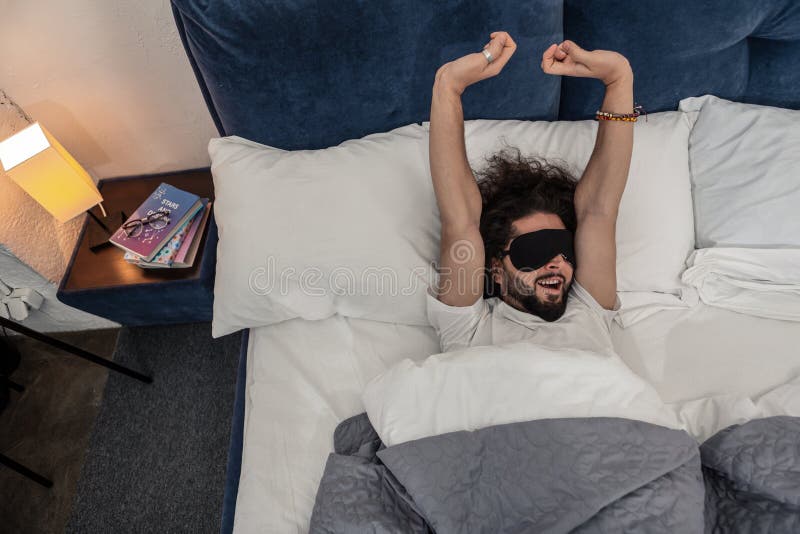 Happy nice man waking up in the morning stock images Happy nice man waking up in the morning stock images