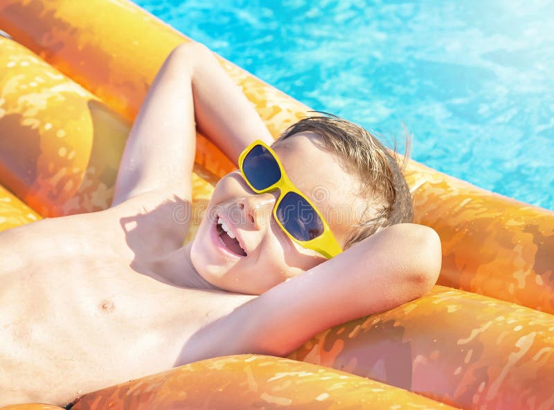 happy nine years old child boy yellow sunglasses having fun orange inflatable ring air mattress swimming pool happy nine 242308018