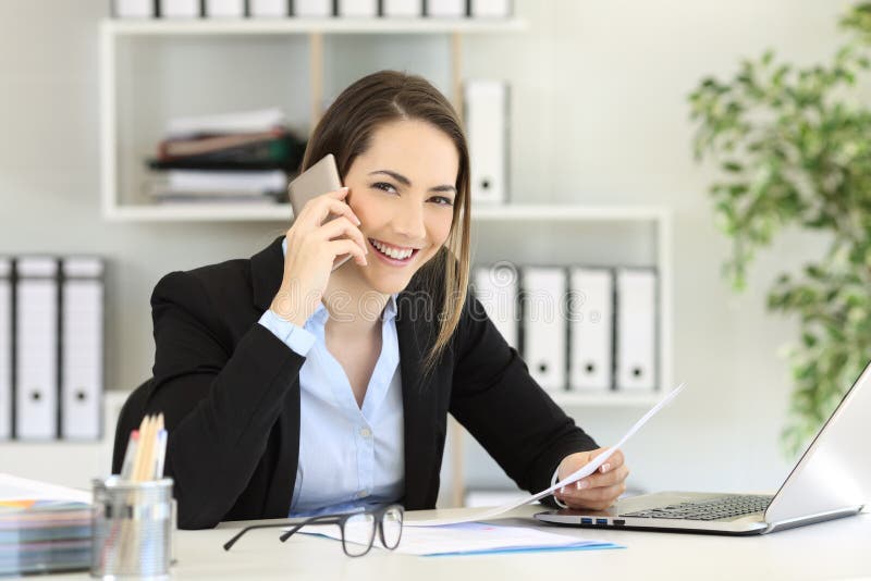 Office worker calling on phone looking at you