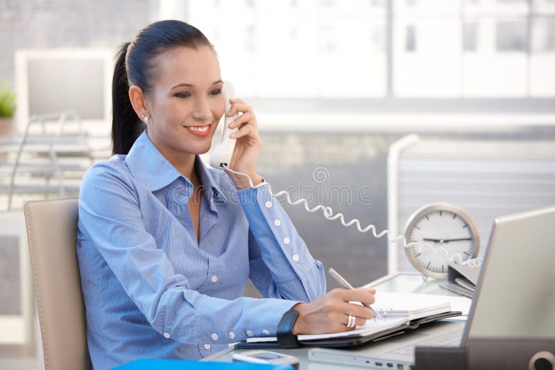 Happy office worker girl on phone call