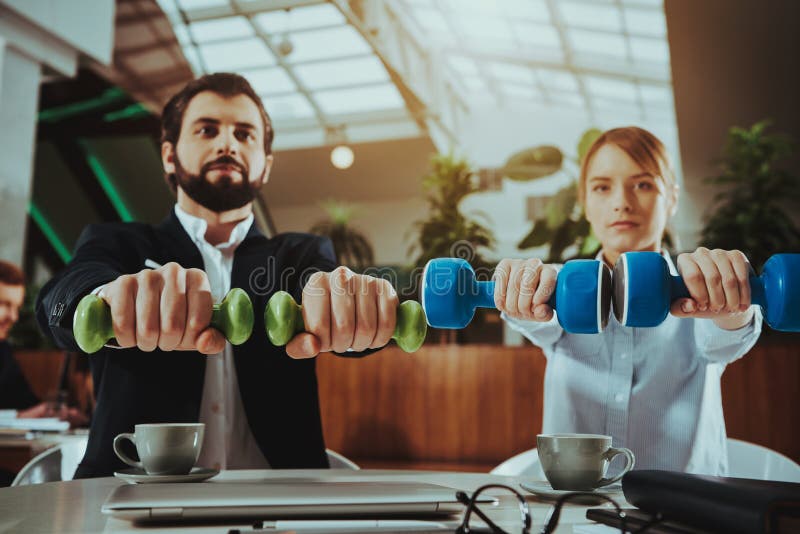 Happy Office Workers Working with Dumbbells stock images Happy Office Workers Working with Dumbbells stock images
