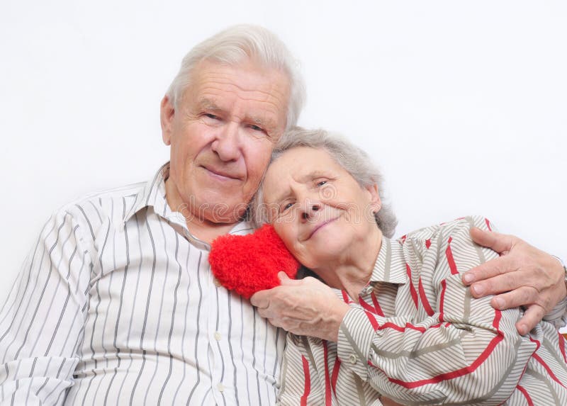 Happy old couple with red heart