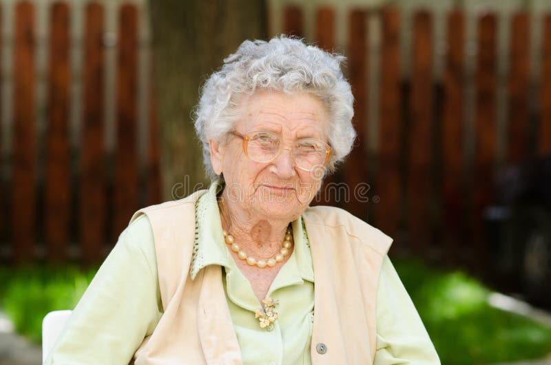Happy old woman sitting and relaxing stock images Happy old woman sitting and relaxing stock images
