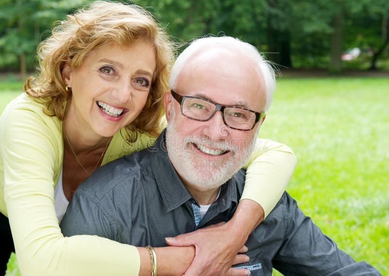 Happy older couple smiling and showing affection