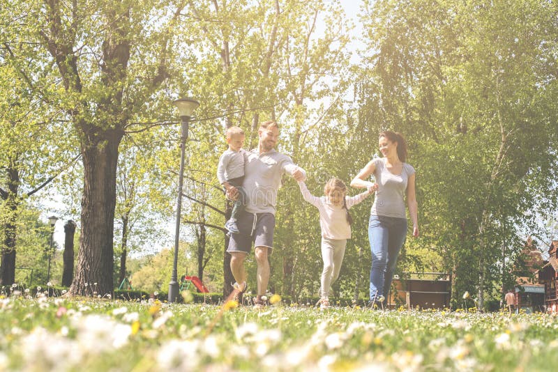 Happy parents playing with their children in the meadow. royalty free stock images Happy parents playing with their children in the meadow. royalty free stock images