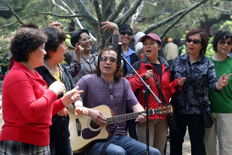 In the temple of heaven park of beijing,there are many people sing and dance every morning.they are very happy. there is a scene of a few of people are singing together now. In the temple of heaven park of beijing,there are many people sing and dance every morning.they are very happy. there is a scene of a few of people are singing together now.