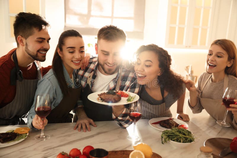 People with Delicious Food in Kitchen. Cooking Class Stock Image