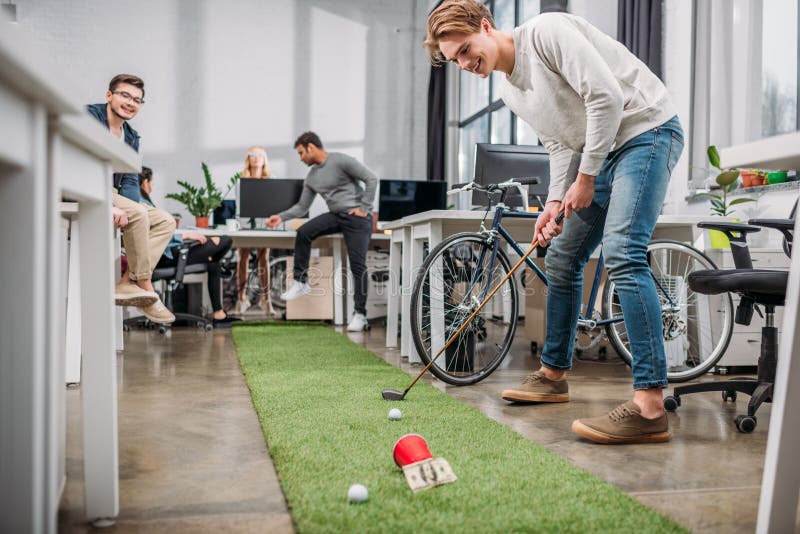 Happy People Playing in Mini Golf at Modern Stock Image - Image of ...