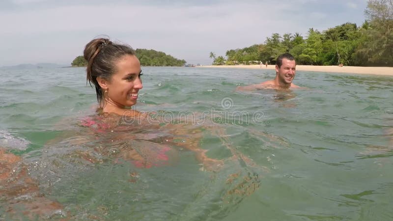 Happy people swimming in sea action camera water pov of young friends group together on beach