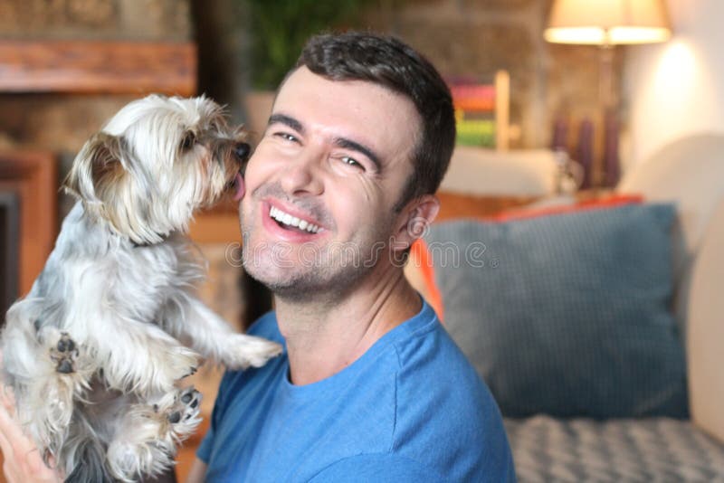 Happy pet owner holding small dog stock image