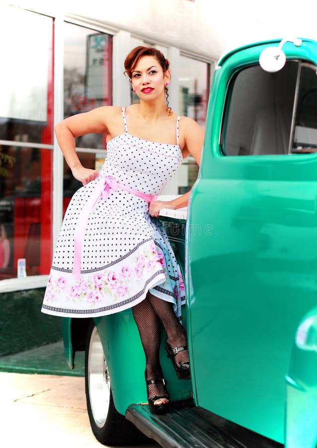 Happy Pinup Girl Sitting on Old Truck