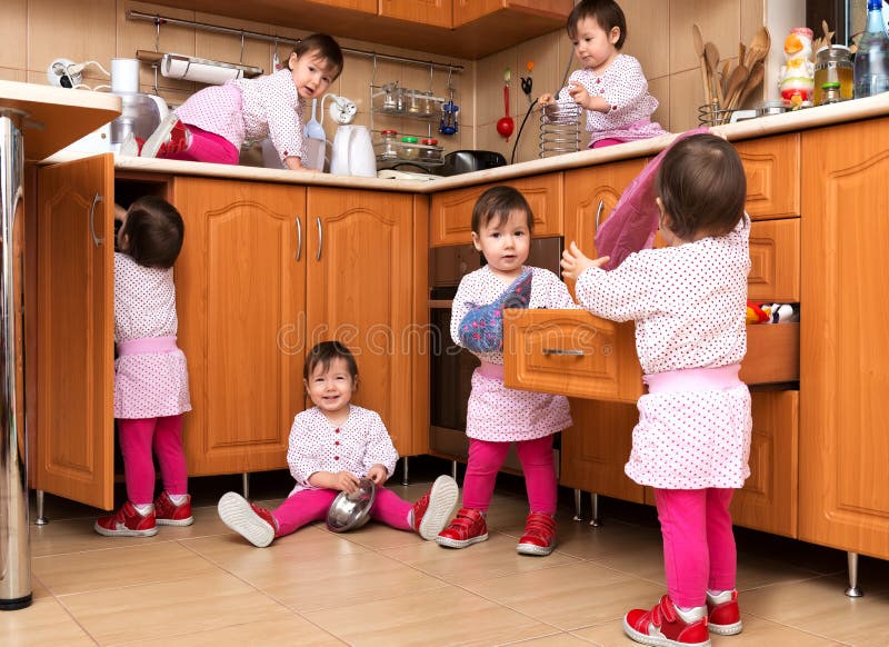 Happy playful girl playing in the kitchen stock photography Happy playful girl playing in the kitchen stock photography
