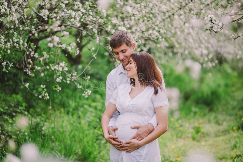 Happy pregnant woman and her husband outdoor
