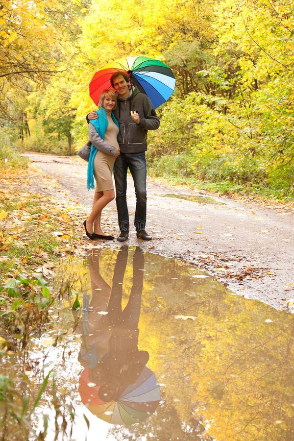 Happy pregnant woman and a man walking