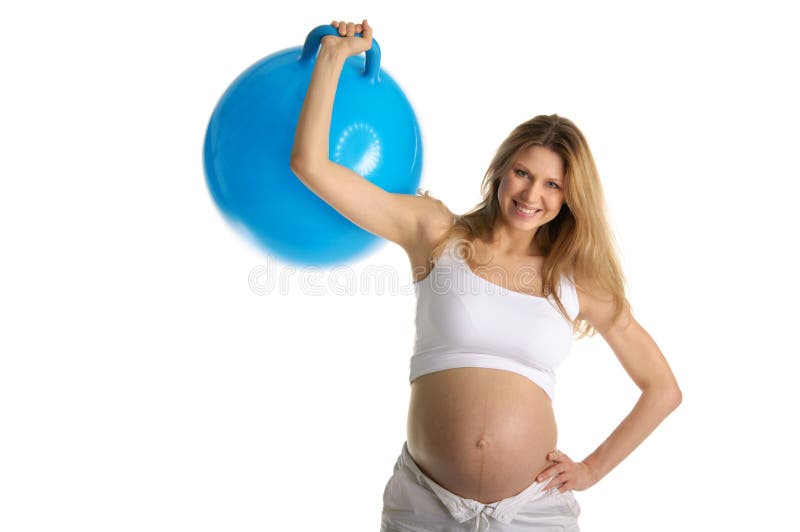 Happy pregnant woman picks up big blue ball