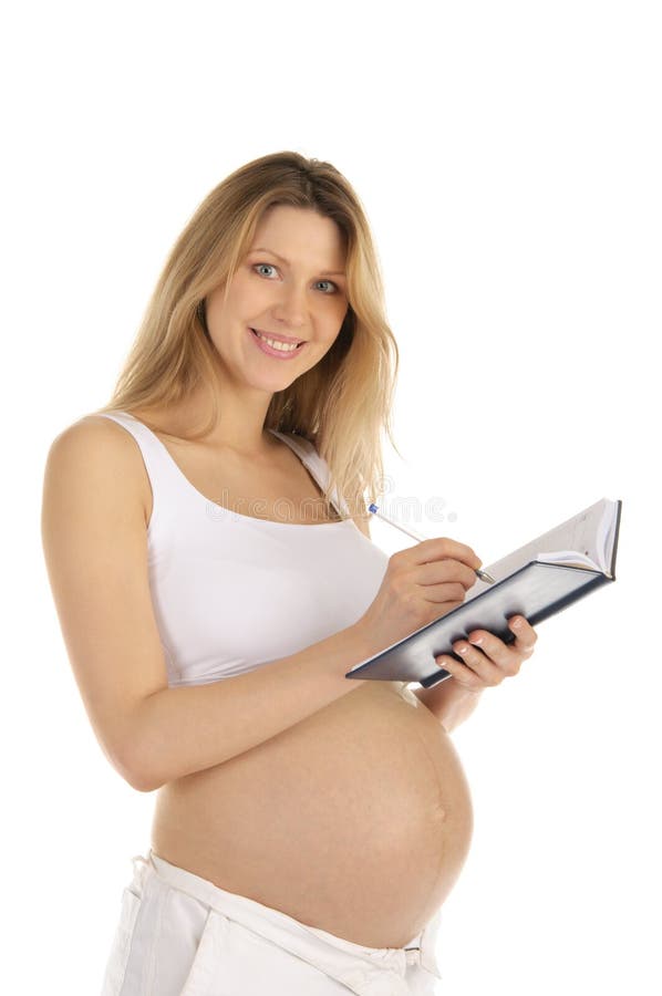 Happy pregnant woman wrote in a notebook