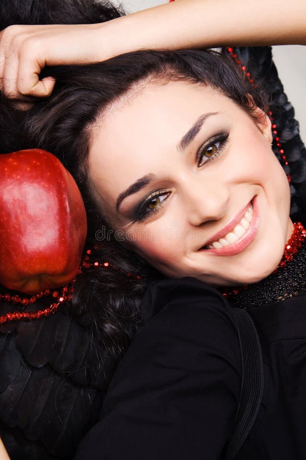 Happy pretty brunette with a big red apple