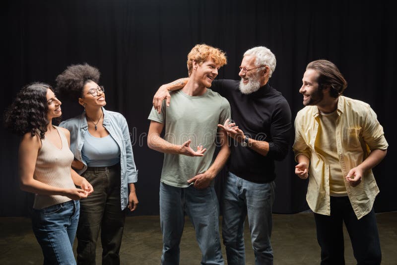Happy producer talking to redhead man royalty free stock photography