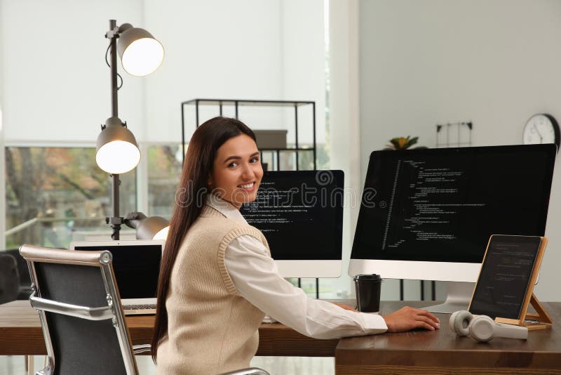 Happy programmer working at desk in office royalty free stock image
