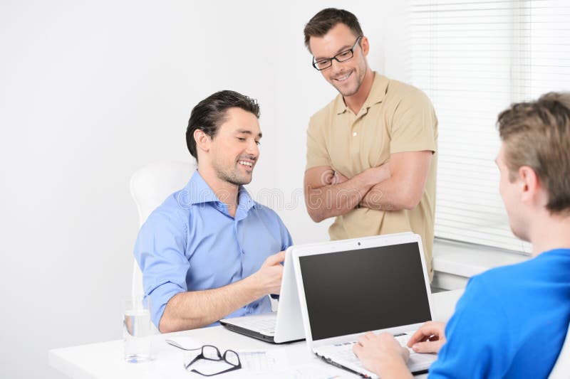 Happy with the project results. Three business people working on stock photo