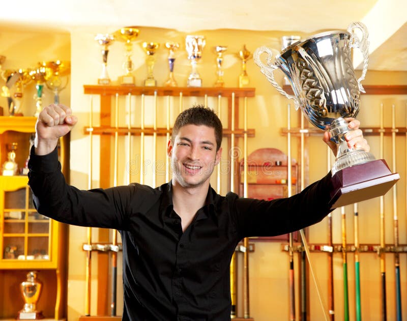 Happy proud winner man with big trophy silver cup