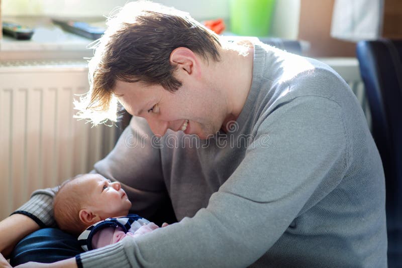 Happy proud young father with newborn baby daughter, family portrait togehter royalty free stock photo Happy proud young father with newborn baby daughter, family portrait togehter royalty free stock photo