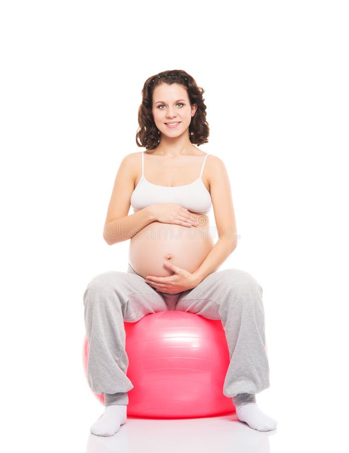 A happy prsgnant woman with a figness ball