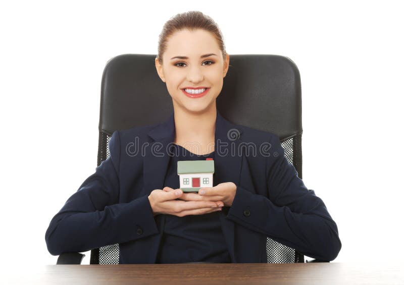 Happy real estate agent, holding a house model stock photos Happy real estate agent, holding a house model stock photos