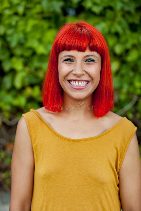 Happy red hair woman in a park