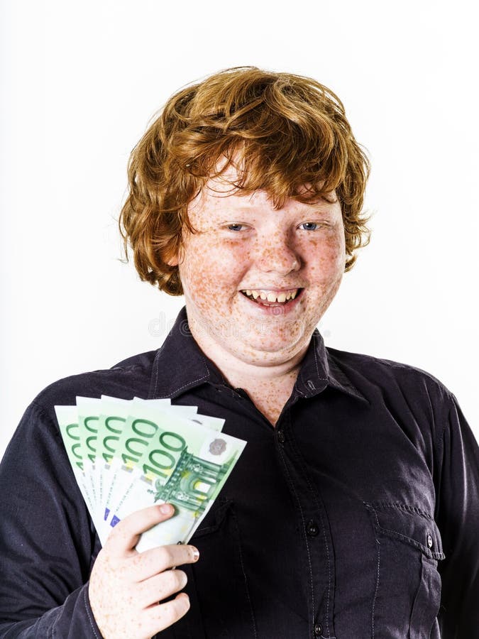 Happy red-haired boy with money