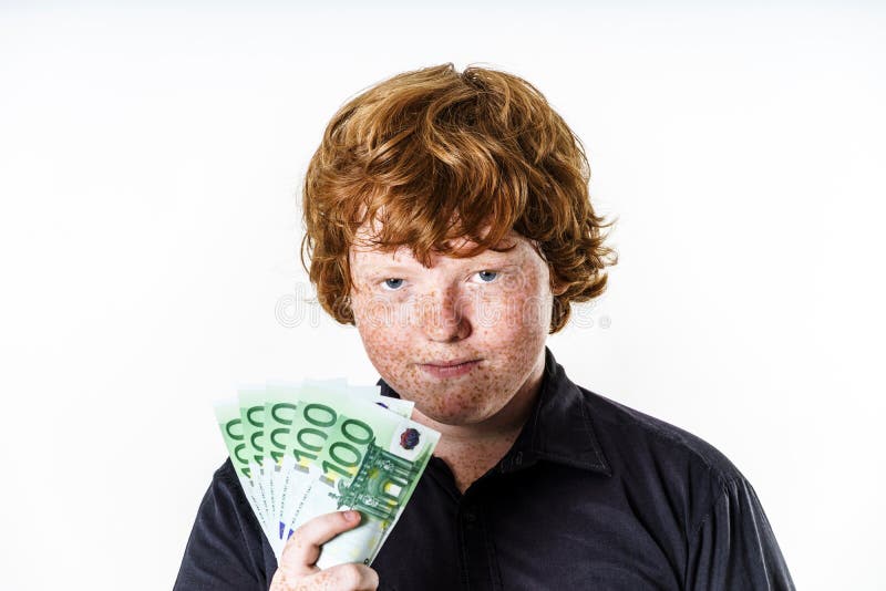 Happy red-haired boy with money