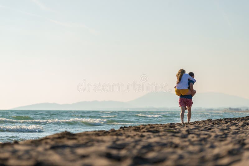Happy Romantic Middle Aged Couple Enjoying Beautiful Sunset Walk On The