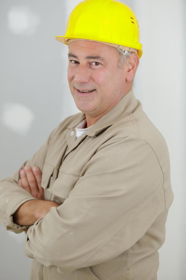 Happy and satisfied engineer posing on construction site royalty free stock image