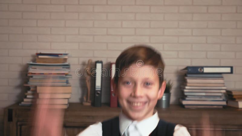 Happy schoolboy jumps showing his joy from education