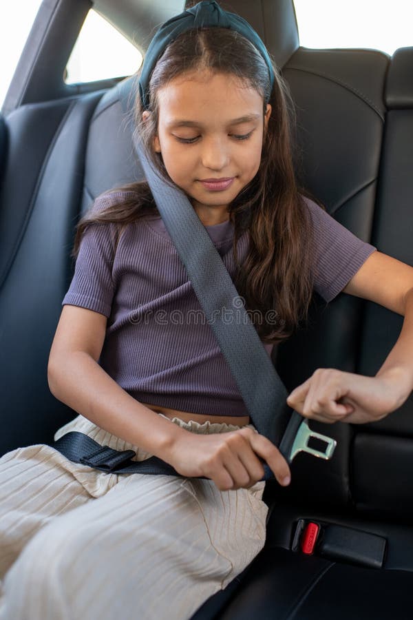 Premium Photo  Serious schoolgirl looking aside while sitting in car