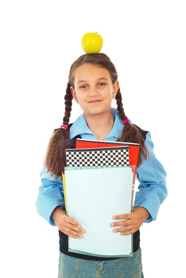 Happy schoolgirl holding apple on head stock photography