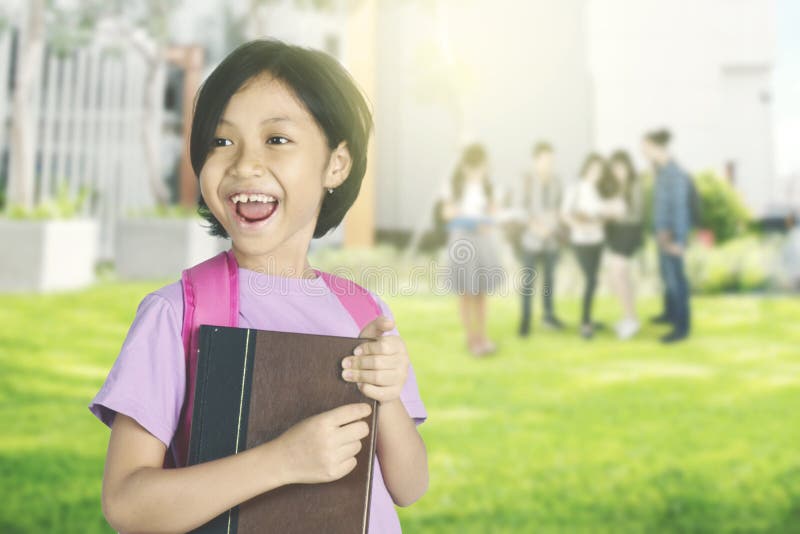 Happy Schoolgirl Holding a Textbook in the Park Stock Image - Image of ...