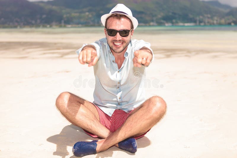 Happy Seated Young Man Pointing His Fingers Stock Photo - Image of ...