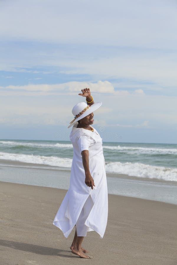Happy Senior African American Woman Dancing on Beach royalty free stock images Happy Senior African American Woman Dancing on Beach royalty free stock images