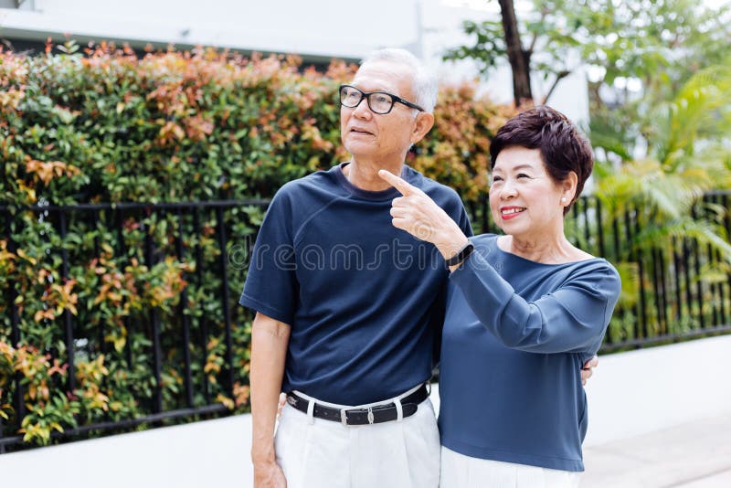 Happy senior Asian couple walking and pointing in outdoor park and house. royalty free stock photography Happy senior Asian couple walking and pointing in outdoor park and house. royalty free stock photography