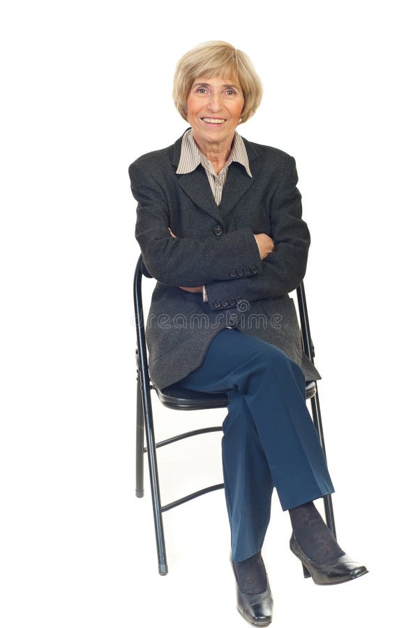 Happy senior business woman on chair