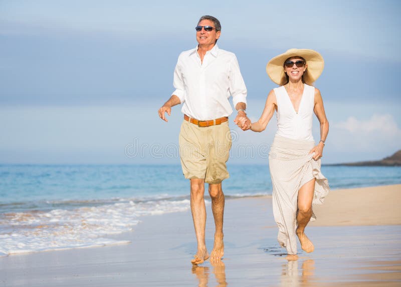 Happy senior couple on the beach. Retirement Luxury Tropical Res stock image Happy senior couple on the beach. Retirement Luxury Tropical Res stock image