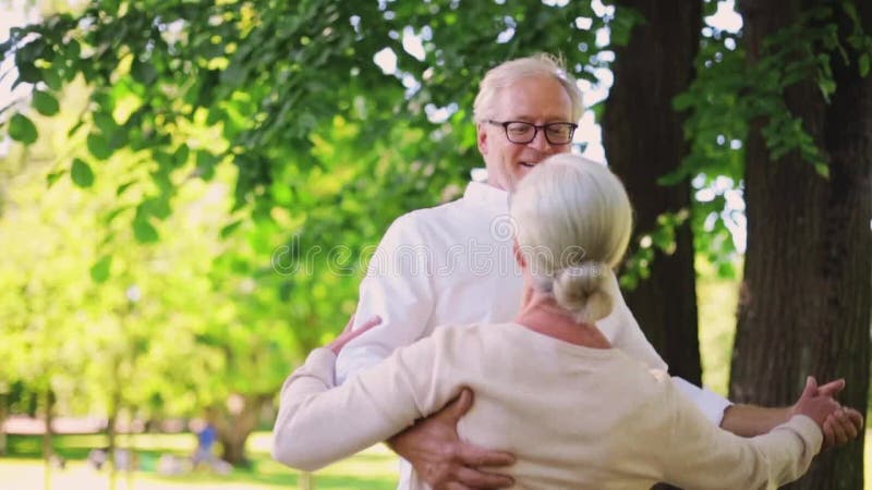 Happy senior couple dancing at summer city park