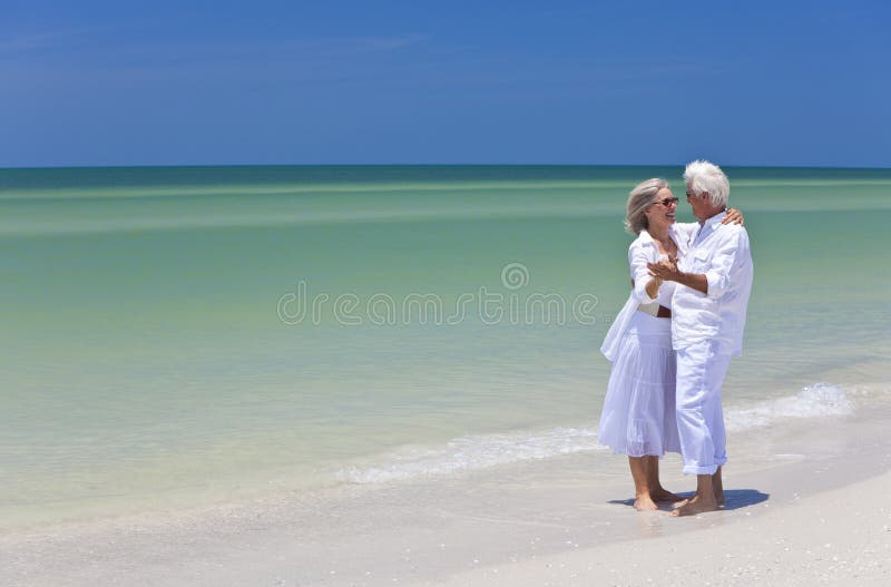 Happy Senior Couple Dancing on Tropical Beach