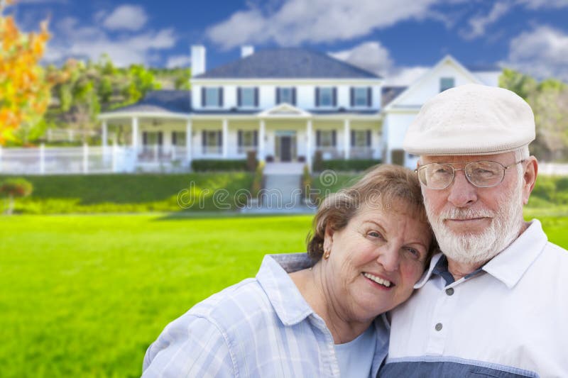 Attractive Happy Senior Couple in Front Yard of House. Attractive Happy Senior Couple in Front Yard of House.