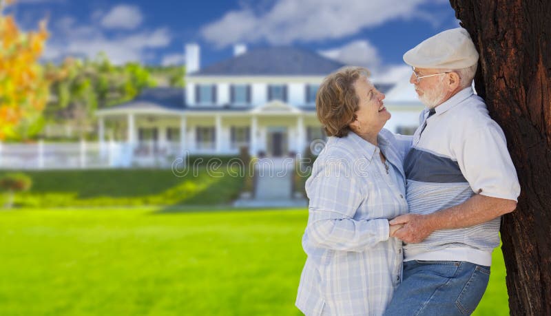 Happy Senior Couple in the Front Yard of Their House. Happy Senior Couple in the Front Yard of Their House.